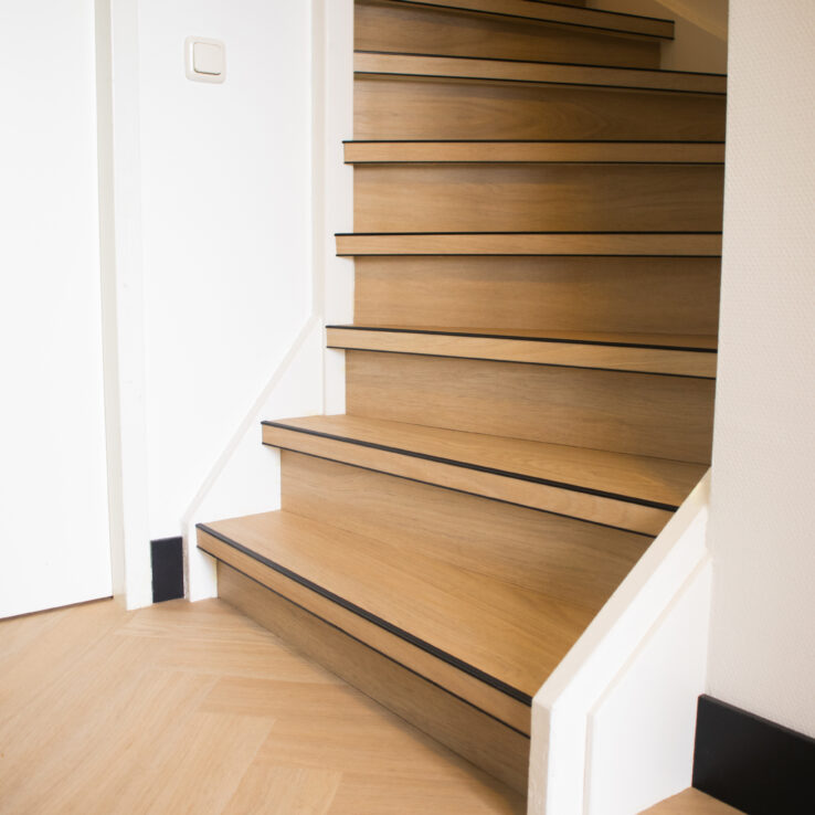 Trap afgewerkt met houtlook PVC vloer en bijpassende PVC-vloer op de begane grond.