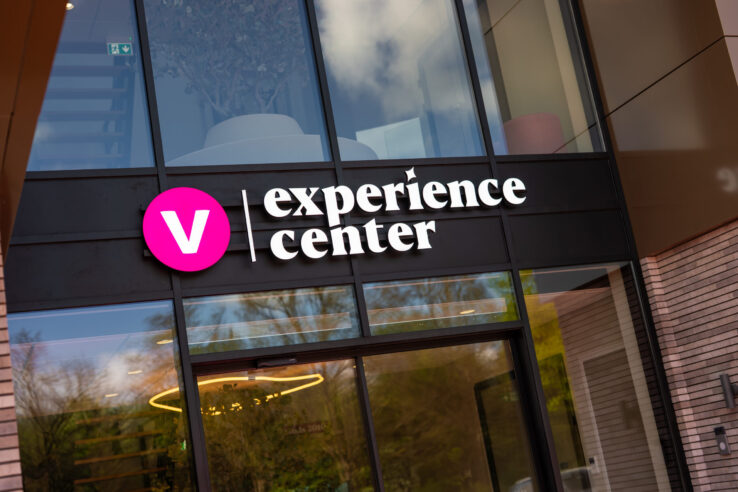 Ingang van het Vivafloors Experience Center met verlicht logo boven de deur